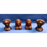 A pair of 19th century treacle glaze pottery rests in the form of a lion,