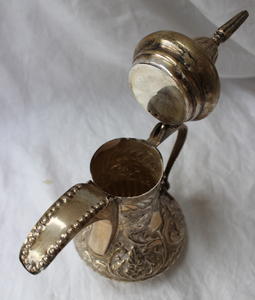 A white metal teapot, with a domed pointed lid, the body embossed with leaves and flowers, - Image 7 of 8