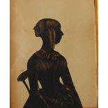 19th century British School
A silhouette of a lady seated on a chair
Cut card and gilt highlights
12