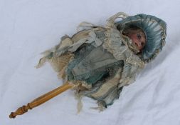 An Armand Marseille AM307 Marotte musical doll in a silk and lace outfit, with fixed blue glass