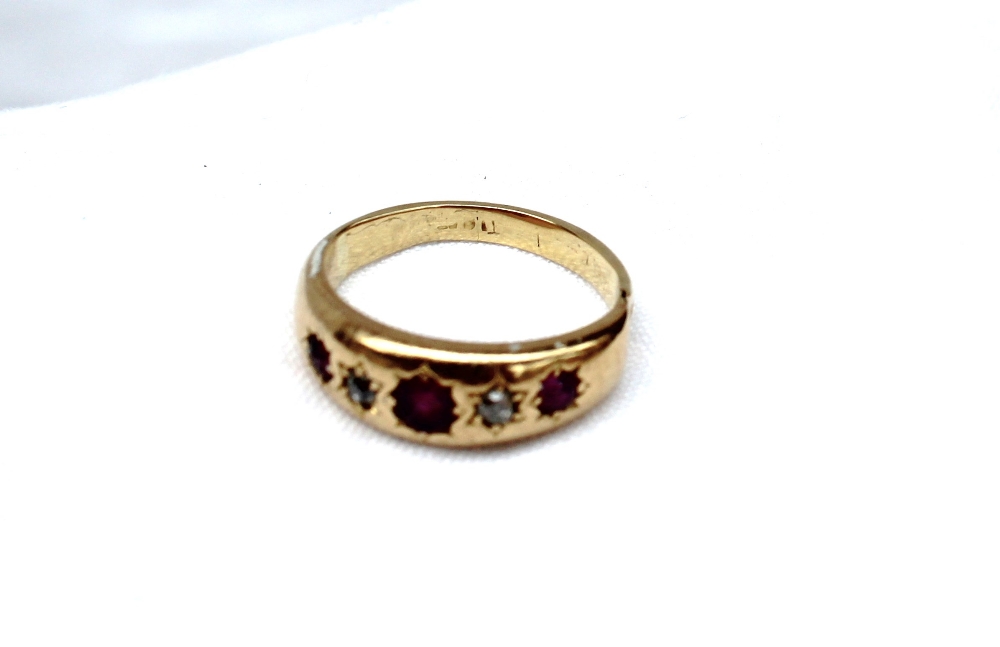 A yellow metal gypsy ring set with three rubies and two old cut diamonds, marked 18ct, - Image 3 of 3