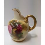 A Royal Worcester porcelain flatback jug, painted with roses and leaves to a blush ivory ground,