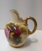 A Royal Worcester porcelain flatback jug, painted with roses and leaves to a blush ivory ground,