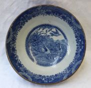 A 19th century blue and white pottery bowl, transfer decorated to the centre with two swans and