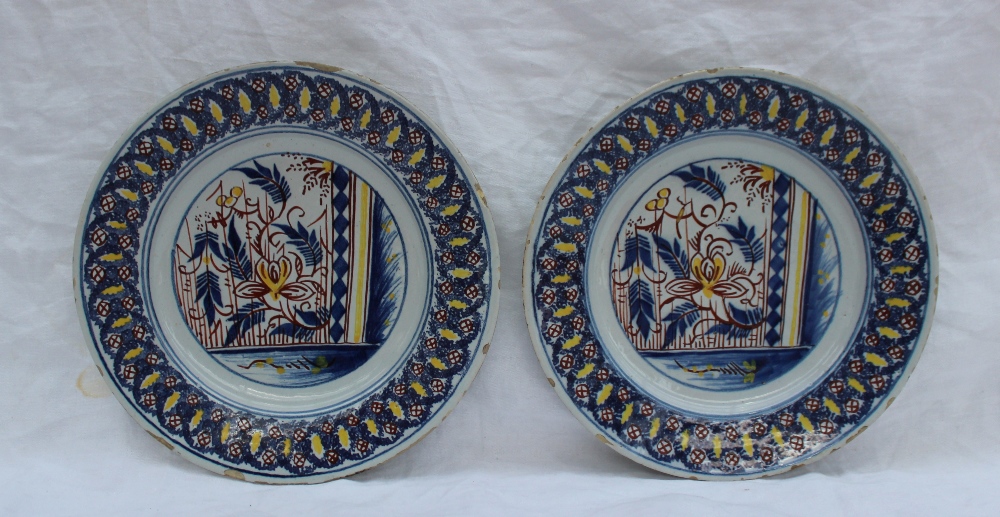 A pair of 19th century tin glazed earthenware plates, decorated with leaves and flower heads, the - Image 2 of 3