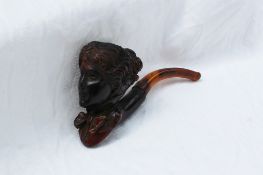 A Meerschaum pipe in the form of a lady with a bow at her neck,