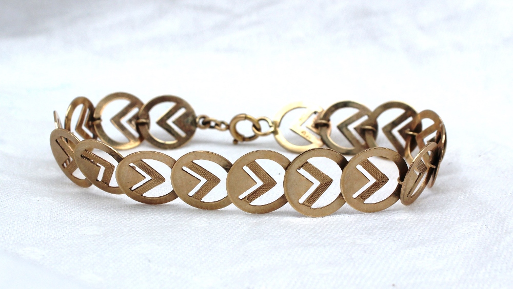 A yellow gold bracelet comprising spherical links with set square decoration, marked 9ct,