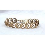 A yellow gold bracelet comprising spherical links with set square decoration, marked 9ct,