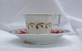 A Coalport porcelain cup and saucer, painted with bands of pink roses to a floral gilt border