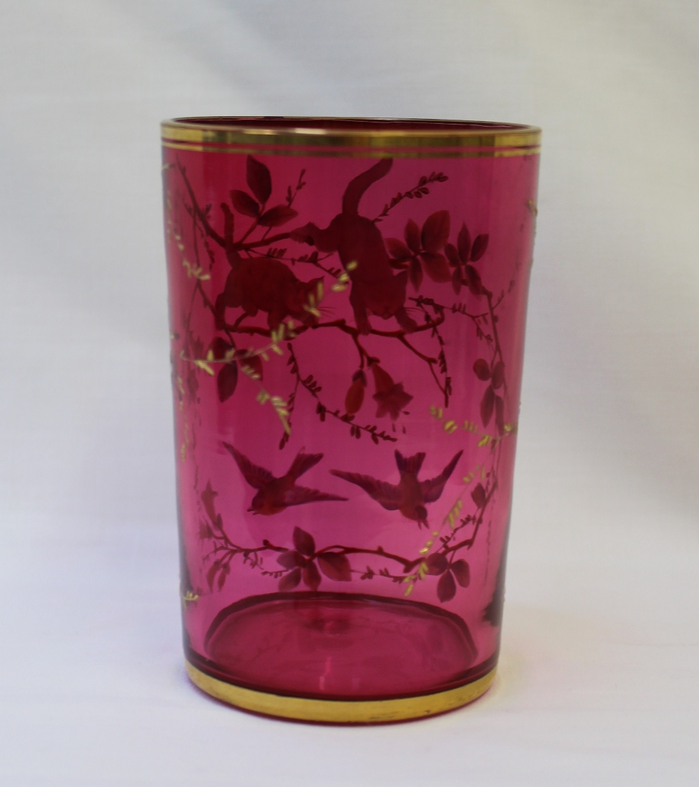 A 19th century cranberry glass goblet with a gilt rim and base enamelled with two cats chasing - Image 2 of 3