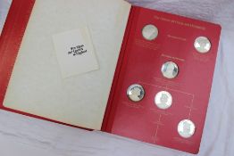 An album of silver medallions depicting the Kings and Queens of England and their places in History,