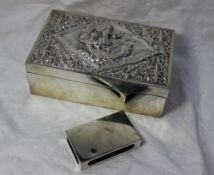 A white metal cigarette box, decorated with Indian figures and scrolling leaves, 18.5cm x 11.