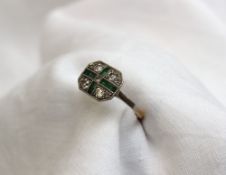 An emerald and diamond ring of Art Deco form, set with nine old brilliant cut diamonds with a