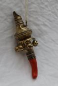 A 19th century silver gilt baby's rattle with a whistle, six bells and a coral teether, possible