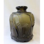 An Art Deco style green glass vase, moulded with elephants on a rocky base,