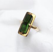 A 9ct yellow gold ring, set with a rectangular tourmaline measuring 18mm x 7mm, claw set,
