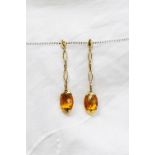 A pair of 18ct yellow gold earrings with a semi precious stone faceted drop