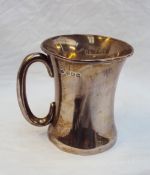 A George V silver christening mug, of waisted form, with a C scroll handle, Birmingham, 1923,