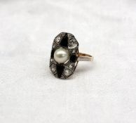 An Art Deco style diamond, pearl and onyx panel ring the central pearl with four onyx panels and