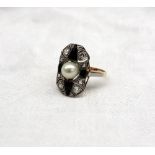 An Art Deco style diamond, pearl and onyx panel ring the central pearl with four onyx panels and