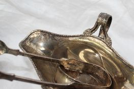 An Edwardian silver twin handled and twin spouted sauce boat, Birmingham, 1905,