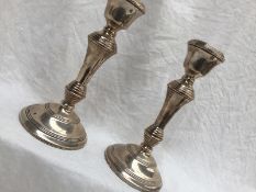 A pair of Elizabeth II silver candlesticks, with a tapering stem on a spreading foot, Birmingham,