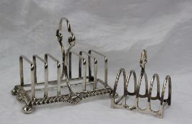 A late Victorian silver six division toast rack, with a shell and gadrooned edge and four ball feet,