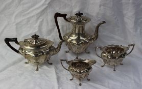 A George V silver four piece teaset, of oval shape, comprising a hot water jug, teapot,