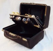 A late Victorian lady's travelling case with silver topped and glass bottles, ink pot, vesta case,