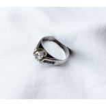 A diamond ring, the central round brilliant cut diamond approximately 0.