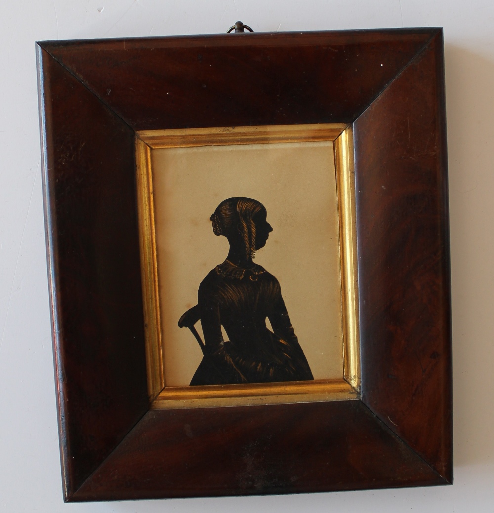 19th century British School
A silhouette of a lady seated on a chair
Cut card and gilt highlights
12