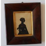 19th century British School
A silhouette of a lady seated on a chair
Cut card and gilt highlights
12