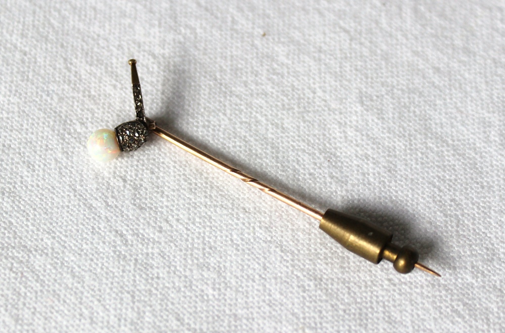 An opal and diamond stick pin in the form of a pipe blowing a bubble