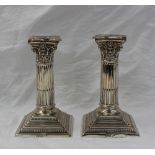 A pair of George V silver candlesticks,