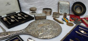 A silver backed hand mirror, together with cased silver spoons, silver napkin ring,