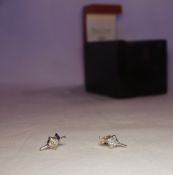 A pair of 18ct white gold single stone diamond earrings each set with a princess cut diamond,