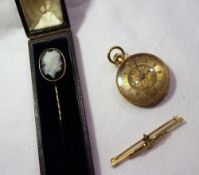 A hardstone cameo stick pin depicting a Romanesque figure head together with a yellow metal fob