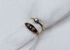 A sapphire and diamond gypsy ring set with three light blue sapphires and two old cut diamonds to