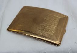 A 9ct yellow gold cigarette case of bowed form with engine turned decoration,