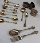 A late Victorian silver fork and spoon set, cast with cherub heads, leaves and lattice on a