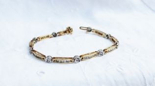 A tennis bracelet set with round brilliant cut diamonds to a yellow metal setting marked 14k