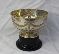 A late Victorian silver rose bowl, decorated with swags, bows and gadrooning, on a pedestal foot,