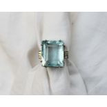 An Aquamarine and diamond dress ring the rectangular faceted aquamarine measuring 18mm x 15mm x 11mm