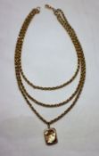 A yellow metal three strand Albert chain marked 9ct , together with a 9ct yellow gold locket,