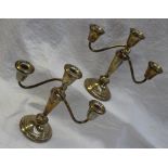 A pair of white metal two branch candelabra with scrolling arms ,