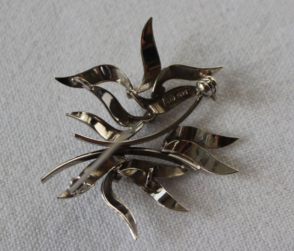 A 14ct white gold and diamond set brooch, with textured leaves set with five brilliant cut diamonds, - Image 3 of 3