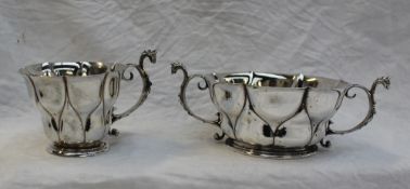 An Edwardian silver twin handled bon bon dish with a lobed body, and a matching tea cup, London,