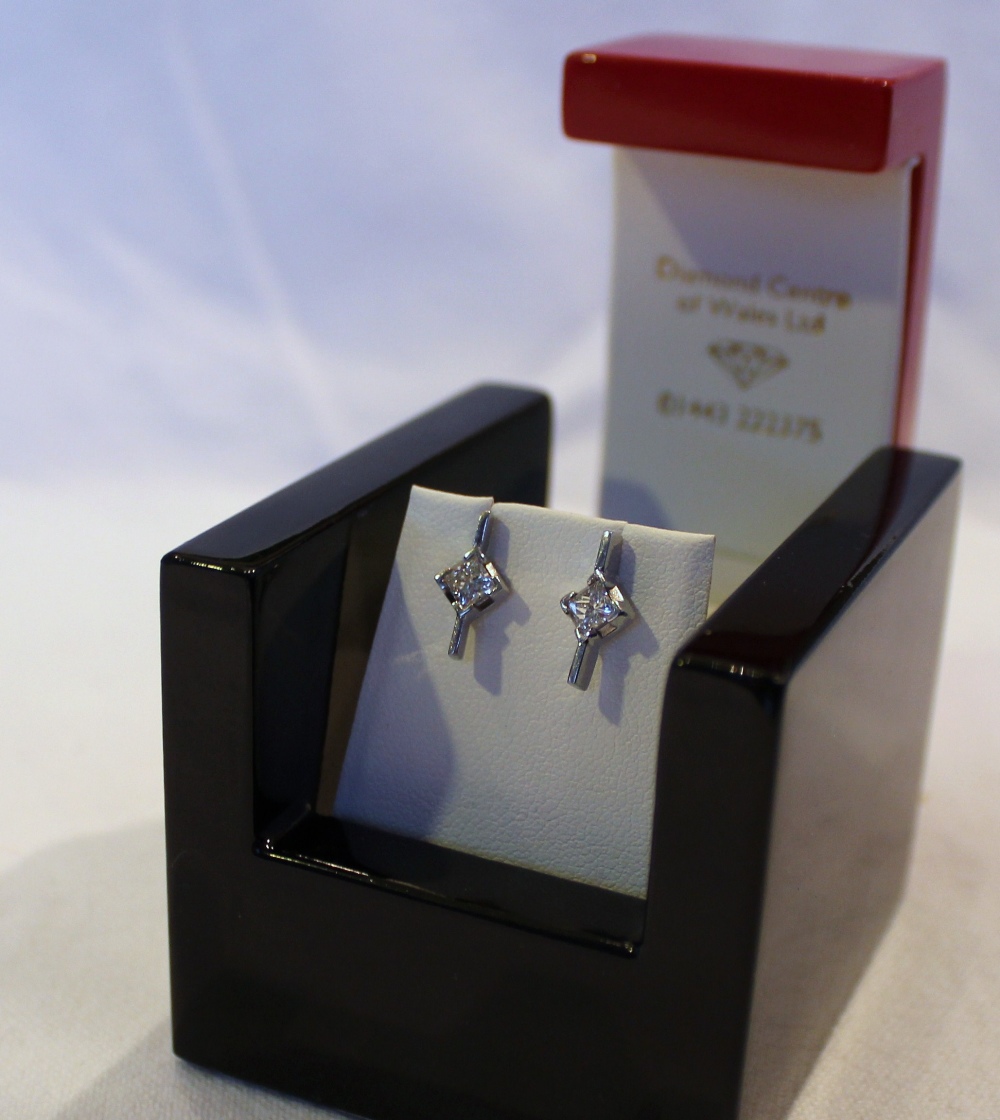 A pair of 18ct white gold single stone diamond earrings each set with a princess cut diamond, - Image 2 of 2