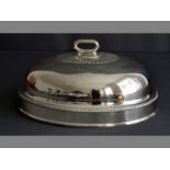 A SILVERPLATE MEAT DOME removable handle, body with gadroon border and reeded rim, 34 by 25cm.