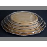 A GRADUATED SET OF FOUR SILVERPLATE MEAT PLATTERS gadroon borders, each platter complete with